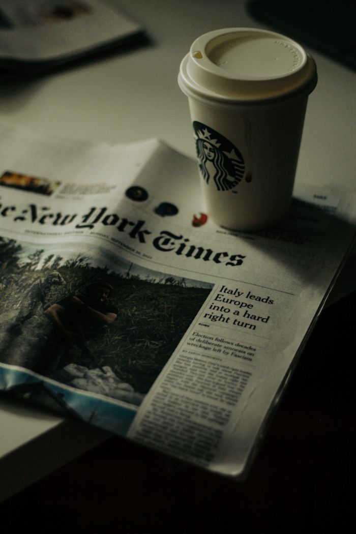 about-us-01 Relax with a coffee and newspaper in a cozy New York setting. Perfect for morning routines.
